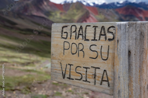 sign saying "Gracias por su visita" or "Thank you for your visit" near Vinicunca, Rainbow Mountains, Peru