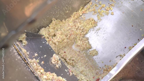 Men 's hands are raking out crushed apple paste for cider production mushed by machine from a stainless steel tank. Fruit vitamin paste. Raw vegan vegetarian healthy food concept 4k