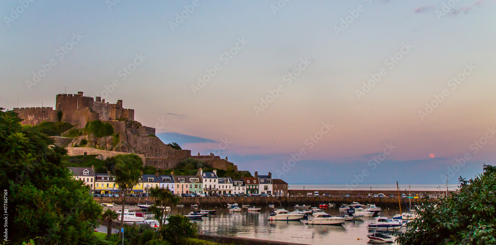 A castle on a hill with a harbour in front