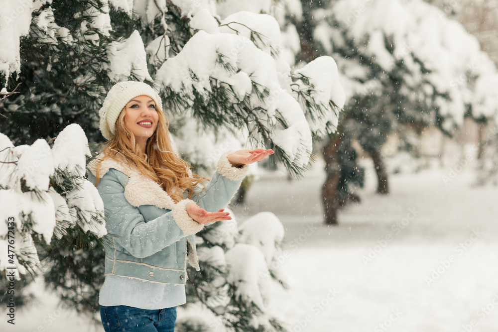 Young beautiful blonde woman in a snowy forest Young beautiful blonde woman in a snowy forest