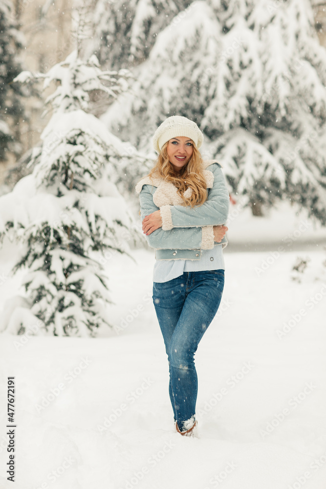 Young beautiful blonde woman in a snowy forest Young beautiful blonde woman in a snowy forest