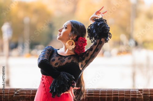 Hispanic woman dancing flamenco in traditional dress photo