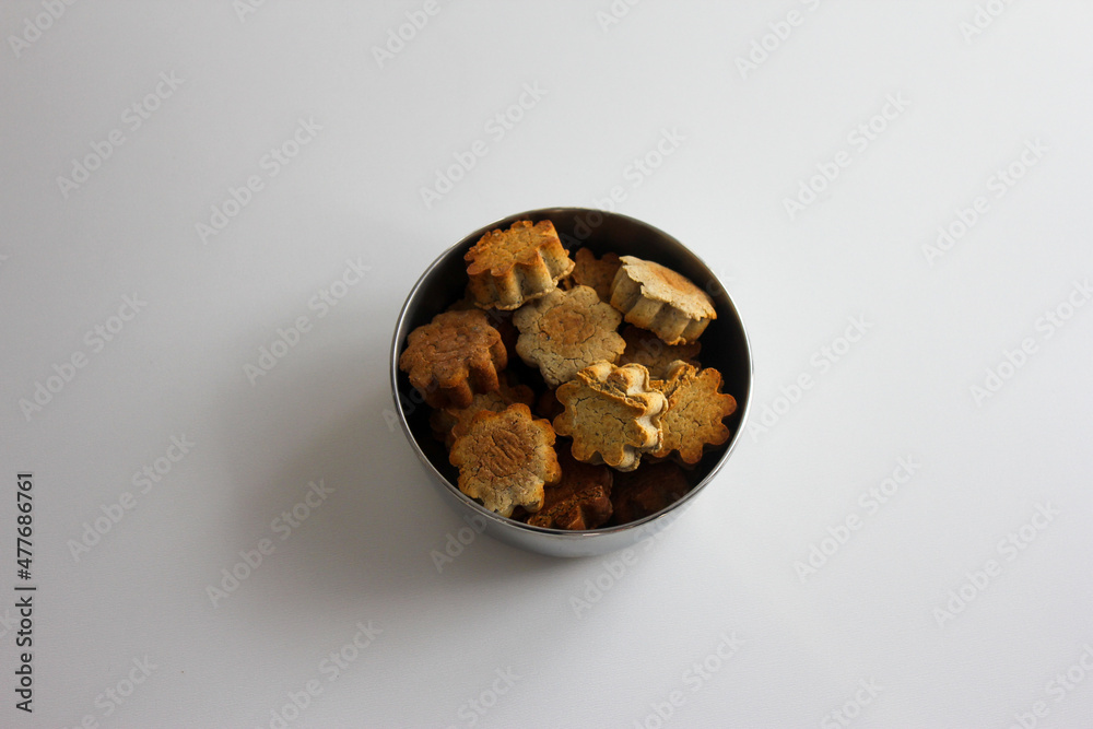Dog cookie in stainless bowl Dog cookie in stainless bowl