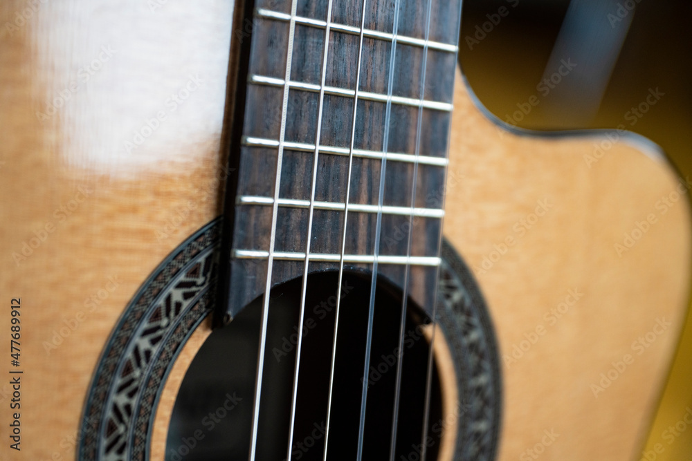 macro shots of a guitar, a fragment of a guitar, acoustic guitar, photos of a guitar in the daylight