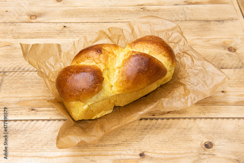 Brioche, made from a paste with eggs, yeast, milk, butter and sugar. The crust is browned before baking, thus obtaining its characteristic color, while the crumb is a paler yellow. photo