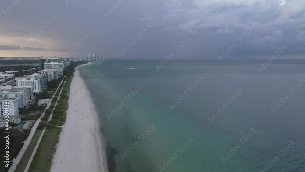 Dark heavy sunset cloud over Surfside beach at dusk, Miami aerial Dark heavy sunset cloud over Surfside beach at dusk, Miami aerial