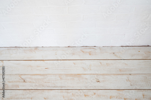 White brick wall and old wooden background