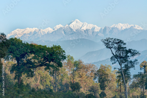 Beautiful view of trees of Silerygaon Village with Kanchenjunga mountain range at the background, morning light, at Sikkim, India photo