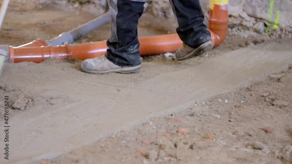 worker sweeping a dusty floor with sewage pipes on floor area stock video worker sweeping a dusty floor with sewage pipes on floor area stock video