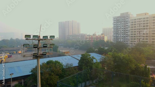 dharavi bus depot india bigest slum drone shot early morning covid 19 stadium lights. photo