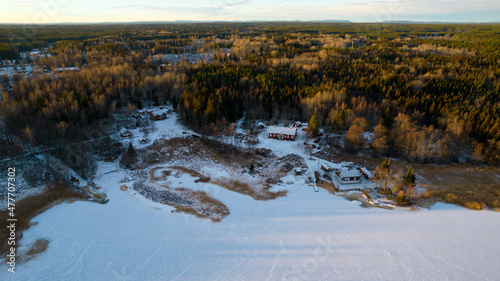 Aerial view of little Swedish village with islands and forests on a Baltic sea coast at winter time. Drone photography - winter in Gavleborg County, Axmar Burk Sweden photo