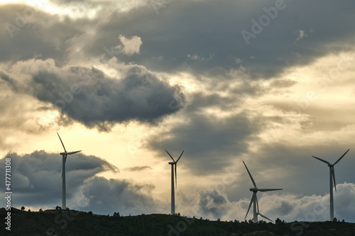 Wind turbines in a wind farm in the mountains at sunset. green ecological energy.