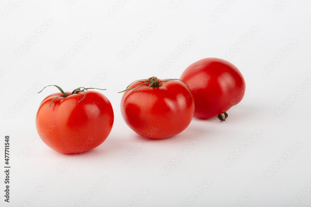 Ripe red tomatoes on a white background. Ripe red tomatoes on a white background.
