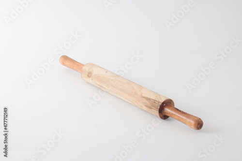 A small wooden rolling pin, usually used to flatten dough.
