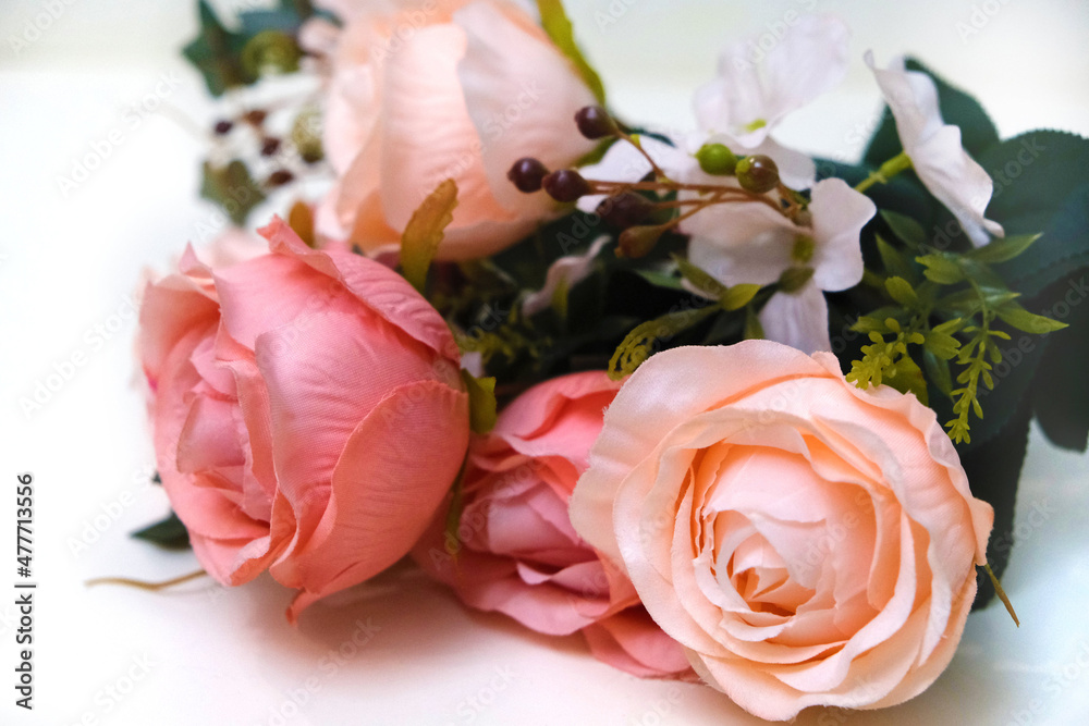 Bouquet of artificial pink roses on white background, home decor Bouquet of artificial pink roses on white background, home decor