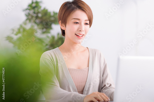 Young woman working on laptop at home, work from home, stay safe during coronavirus covid-19 concpt photo