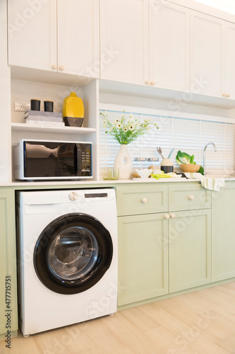 Wallpaper Mural Modern green kitchen interior with washing machine and microwave. Torontodigital.ca