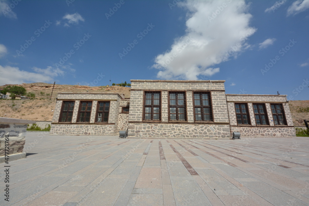 a stone building with large windows