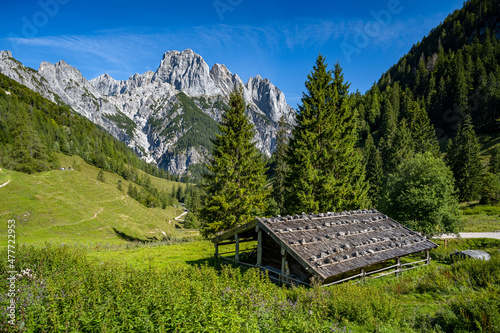 Old wooden hut in front of impressive mountain peaks, Ramsau, Bavaria, Germany