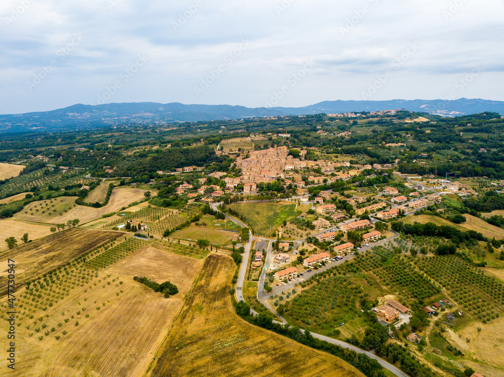 Casale Marittimo, Tuscany, Pisa region, Medieval old town with cypress tress and crops hay, city on a hill top, landscape drone aerial panorama	