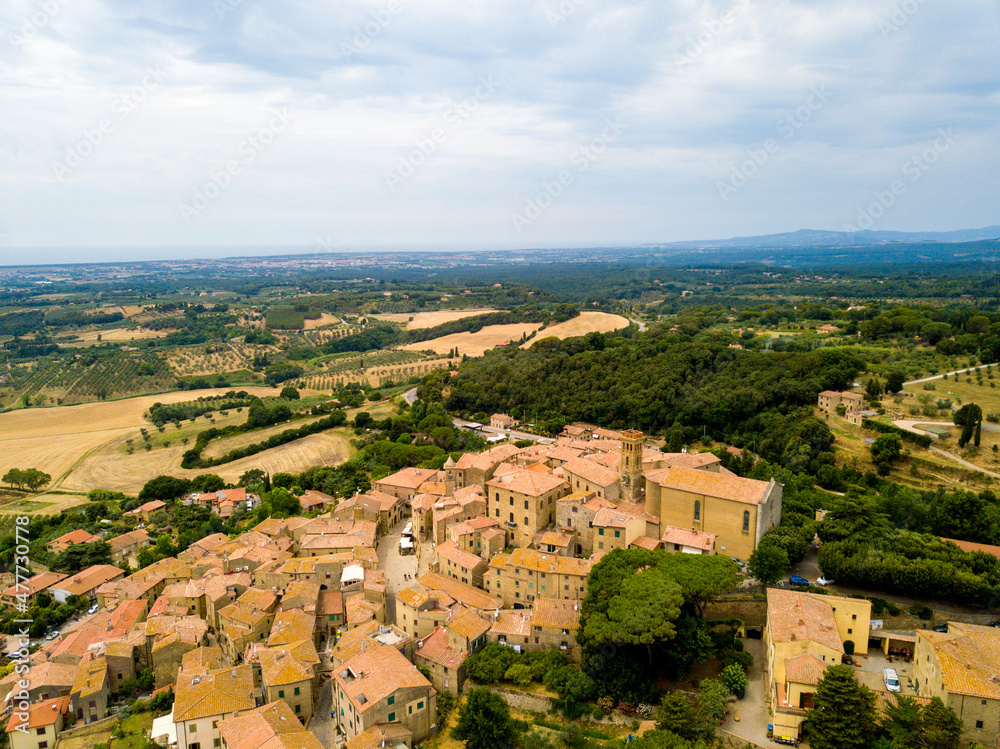 Fototapeta premium Casale Marittimo, Tuscany, Pisa region, Medieval old town with cypress tress and crops hay, city on a hill top, landscape drone aerial panorama 
