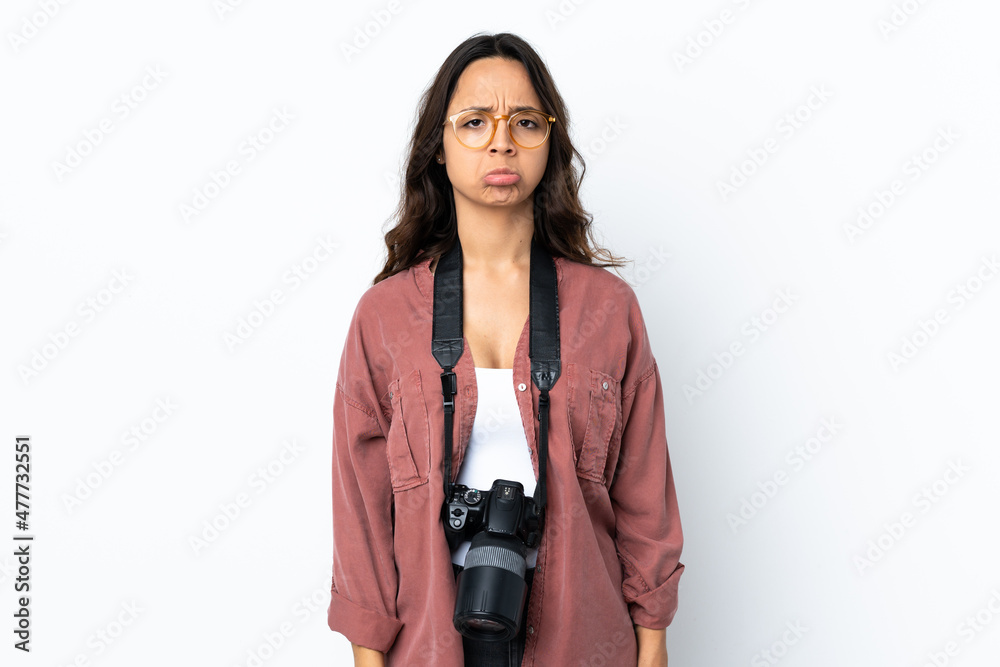 Young photographer woman over isolated white background with sad expression Young photographer woman over isolated white background with sad expression
