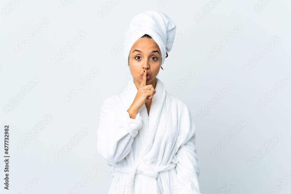 Young woman in bathrobe over isolated white background showing a sign of silence gesture putting finger in mouth Young woman in bathrobe over isolated white background showing a sign of silence gesture putting finger in mouth