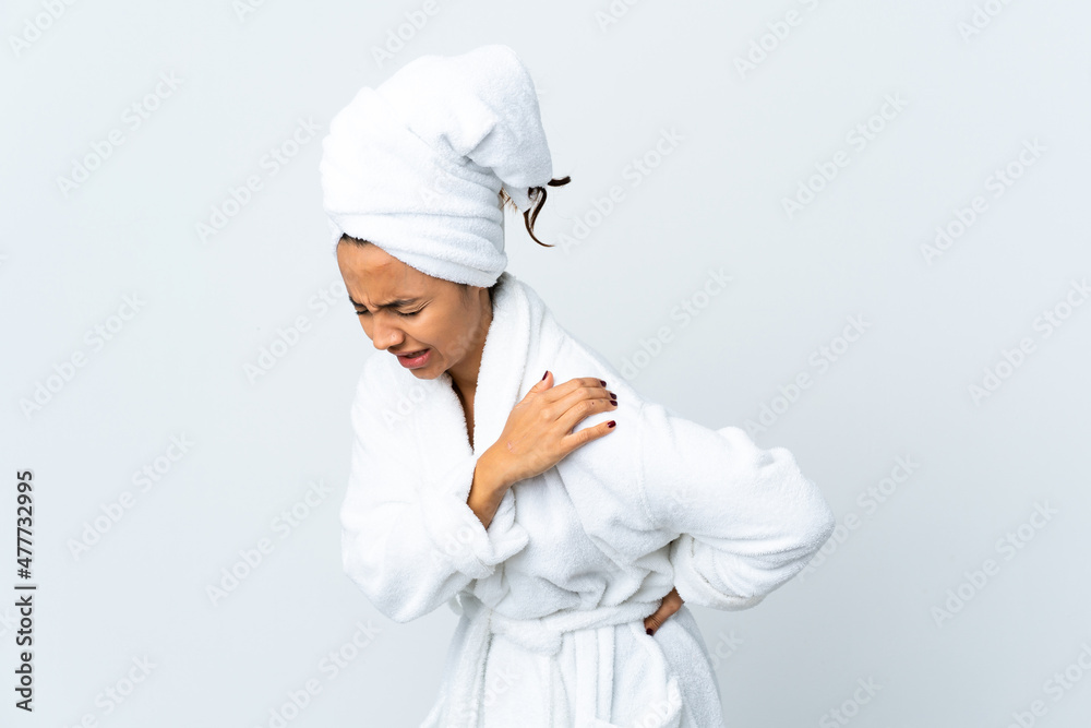 Young woman in bathrobe over isolated white background suffering from pain in shoulder for having made an effort Young woman in bathrobe over isolated white background suffering from pain in shoulder for having made an effort