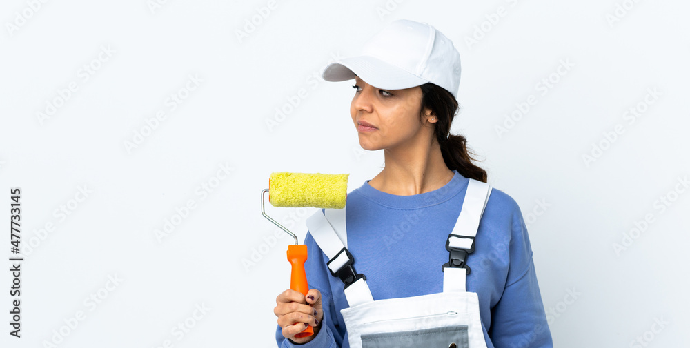 Painter woman over isolated white background looking to the side