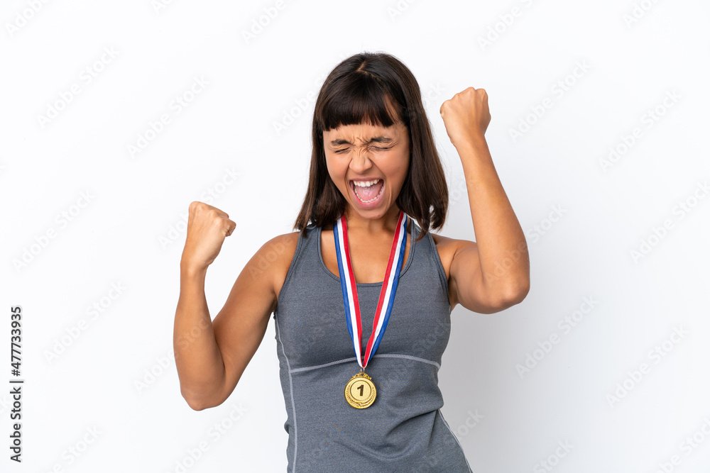Young mixed race woman with medals isolated on white background celebrating a victory Young mixed race woman with medals isolated on white background celebrating a victory