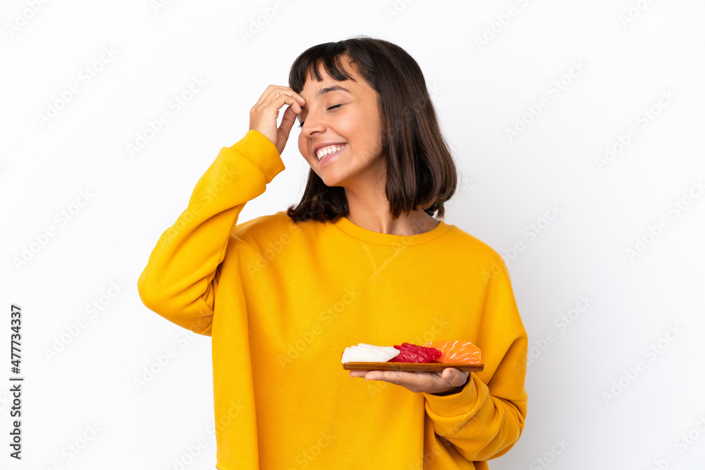 Young mixed race woman holding sashimi isolated on white background smiling a lot Young mixed race woman holding sashimi isolated on white background smiling a lot