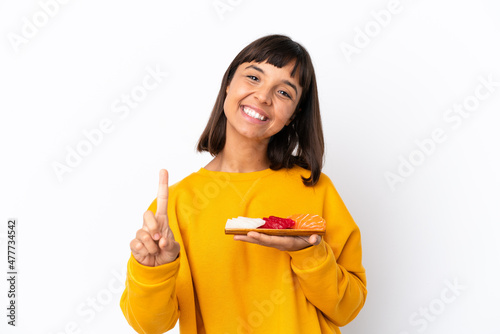 Young mixed race woman holding sashimi isolated on white background showing and lifting a finger