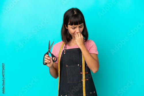 Young mixed race seasmtress woman isolated on blue background having doubts