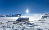 Snowy landscape with sun during winter season on dolomites in Trentino Alto Adige with Rosetta Refuge