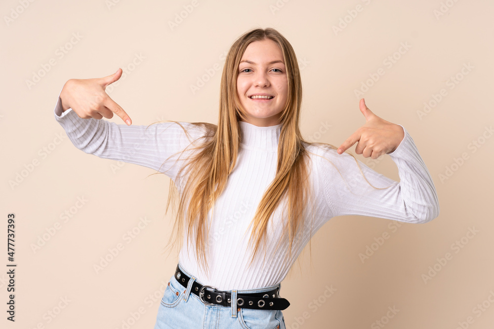 Teenager Ukrainian girl isolated on beige background proud and self-satisfied Teenager Ukrainian girl isolated on beige background proud and self-satisfied