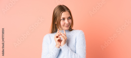 Teenager Ukrainian girl isolated on pink background scheming something