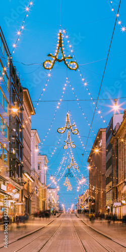 Helsinki, Finland. Night View Of Aleksanterinkatu Street With Railroad In Kluuvi District In Evening Christmas Xmas New Year Festive Illumination photo