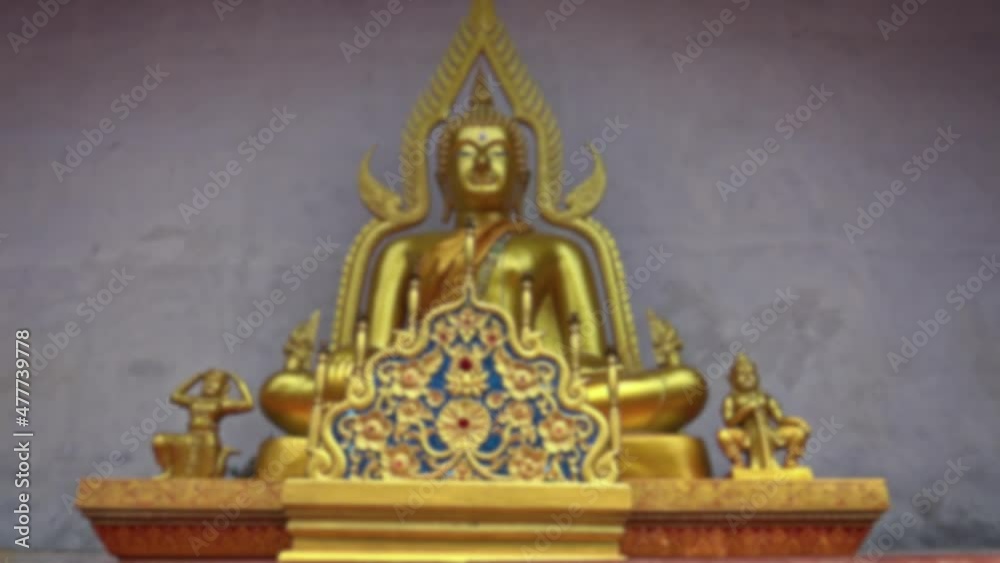Blurred defocused view of golden Buddha statue, eighteen-cube Buddha. A Buddhist temple in the historical center of Chiang Mai. Blurred defocused view of golden Buddha statue, eighteen-cube Buddha. A Buddhist temple in the historical center of Chiang Mai.