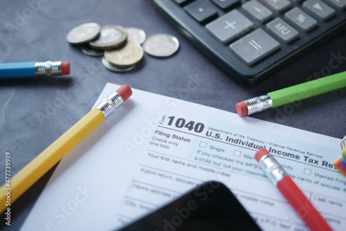 Close up of a Tax return form and pen on table.
