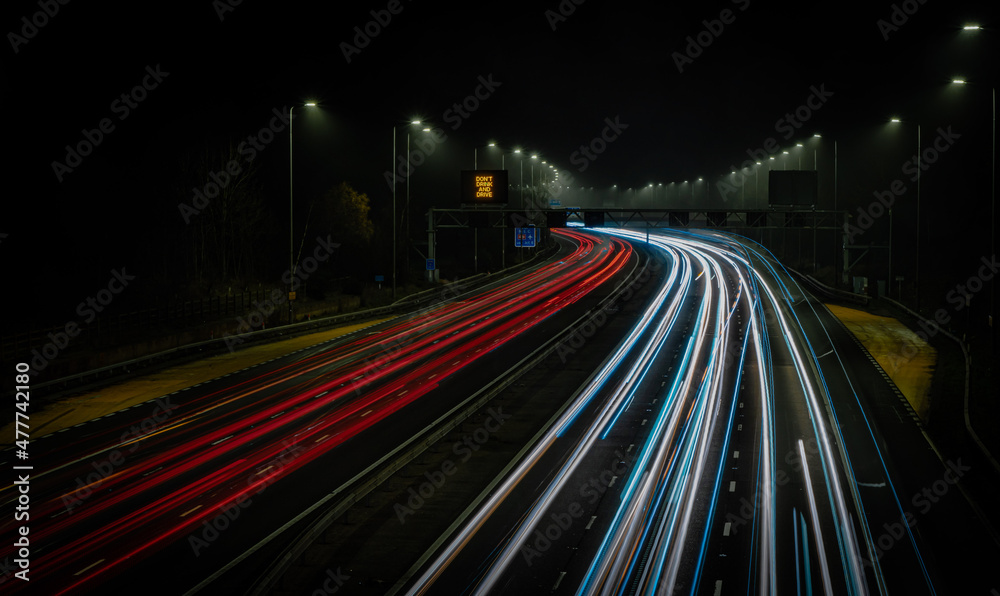 Motorway fast traffic light trails at night	