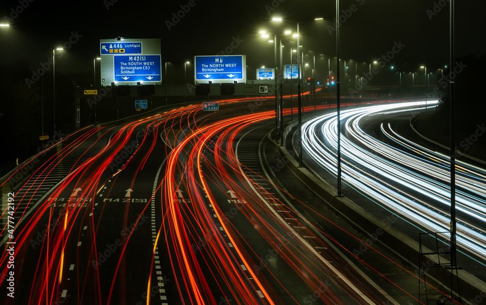 Motorway traffic light trails at a busy junction