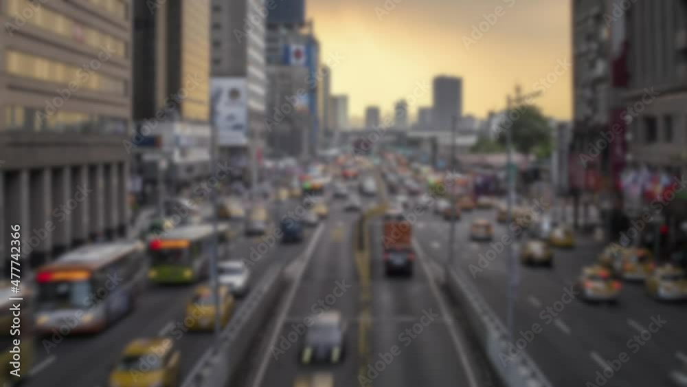 Defocused shot of timelapse of historical Taipei North Gate in Zhongxiao West Road. Different vehicles driving near to the door with sunset. Timelaps busy street traffic Taiwan Defocused shot of timelapse of historical Taipei North Gate in Zhongxiao West Road. Different vehicles driving near to the door with sunset. Timelaps busy street traffic Taiwan