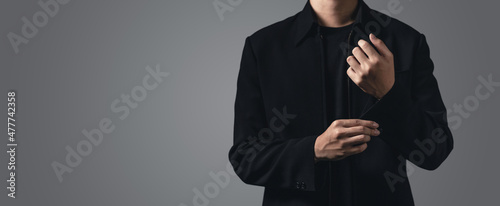 Valokuva business man fixing his cufflink with copy space for text on the grey background