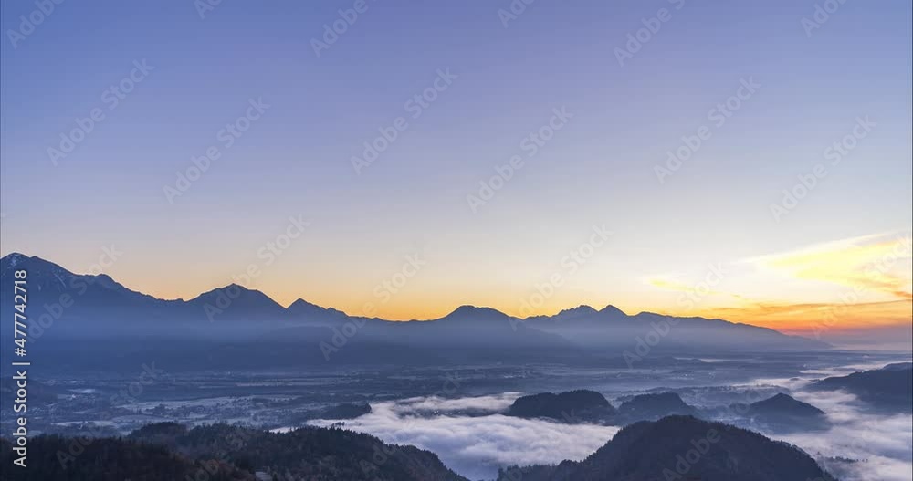 Time lapse of fog moving above lake Bled, Slovenia. Beautiful winter morning. Aerial or elevated view of large basin. Famous castle on rock and island on the lake. Sunrise. Static shot Time lapse of fog moving above lake Bled, Slovenia. Beautiful winter morning. Aerial or elevated view of large basin. Famous castle on rock and island on the lake. Sunrise. Static shot