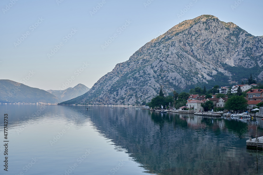 Morning seascape by the sea with mountains and a city in Montenegro
