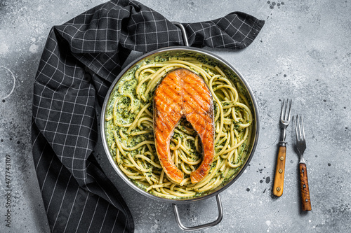 Canvas Print Florentine pasta with creamy spinach sauce and grilled salmon steak