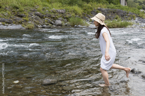 A girl playing with water in the river