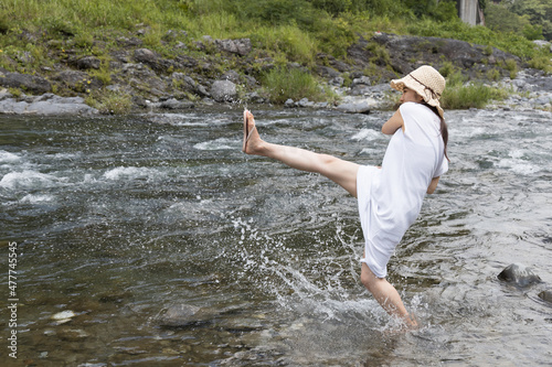 A girl playing with water in the river