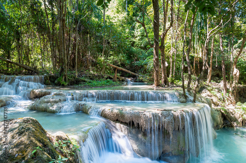 Fototapeta Naklejka Na Ścianę i Meble -  Erawan National Park  in Thailand. Erawan Waterfall is a popular tourist destination and famous for its emerald blue water. Deep forest in tropical climate with fantasy atmosphere. 