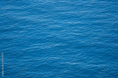 Fototapeta Blue sea water surface with waves, top view